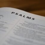 Close-up of open Bible showing the Psalms page with clear typography.